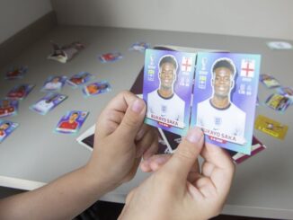 holding up football trading cards